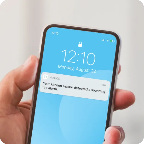 A phone with an alert from a smart senor.
